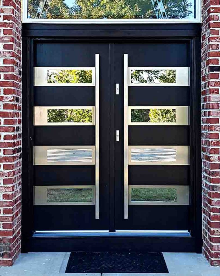 Main door in a double door style with bar handles, glass frame above and reflective glass incorporated