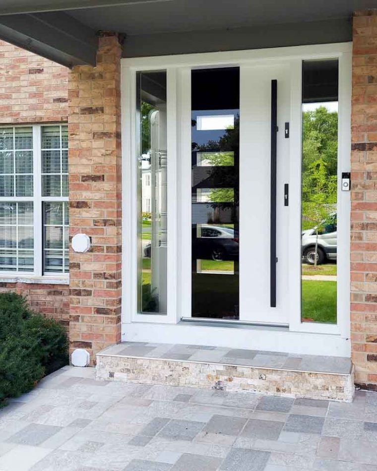 Main door of a house with two sidelights having reflective glass, a bar handle and two locksets