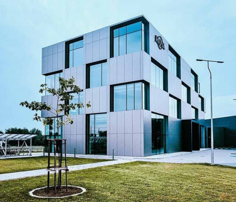 An office building, A modern architectural design of a building with four floors, innovative windows that are matching with the unique design of the commercial property.